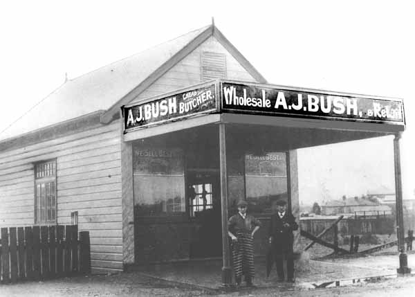 Family history - AJ Bush 1st shop in Broadmeadow, Newcastle with the shop manager Joe Booth and a customer out the front.